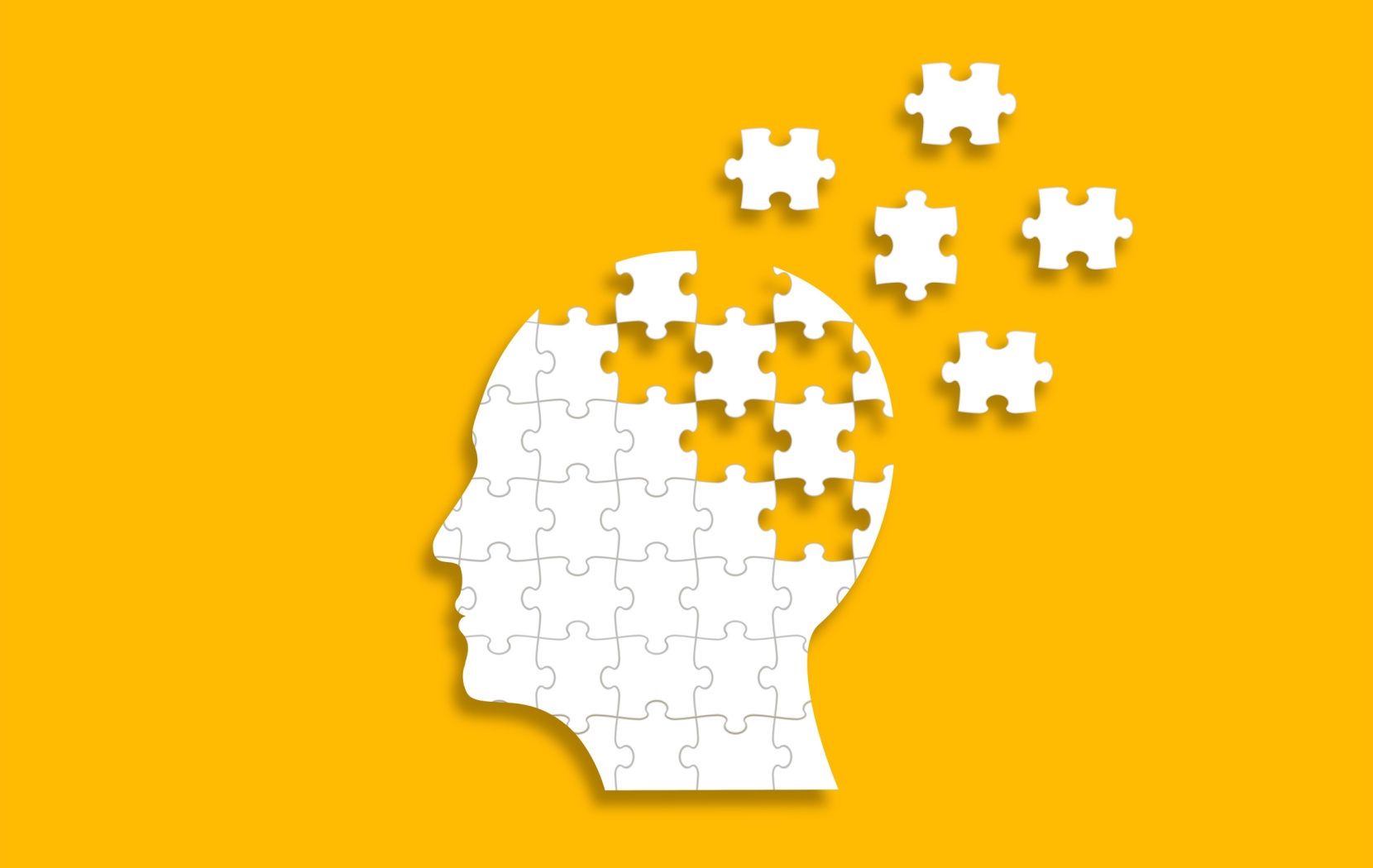 A white head made of puzzle pieces sits on a yellow background. A few pieces of the puzzle have been removed to represent the cognitive decline of Alzheimers.